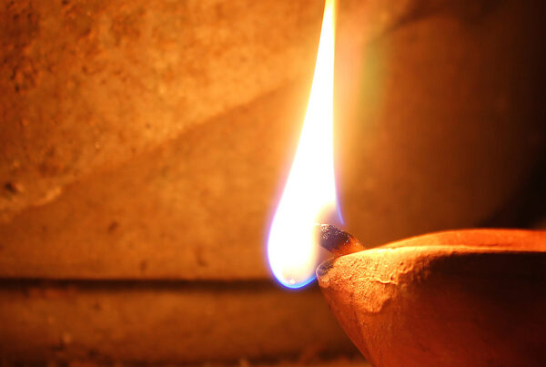 A match lighting a lamp