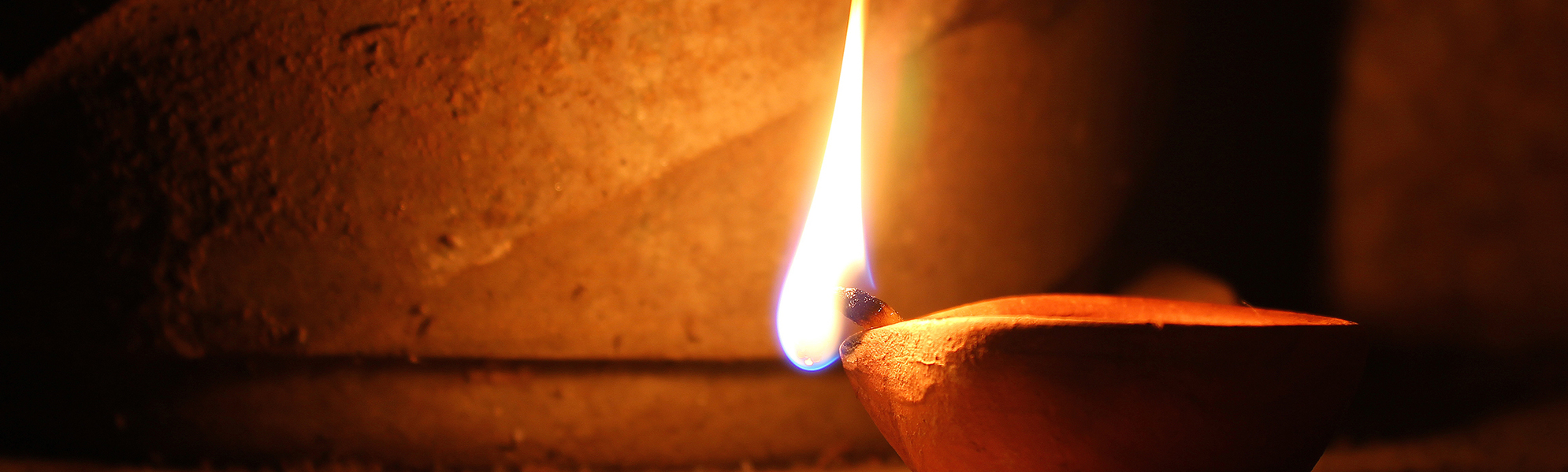 A match lighting a lamp